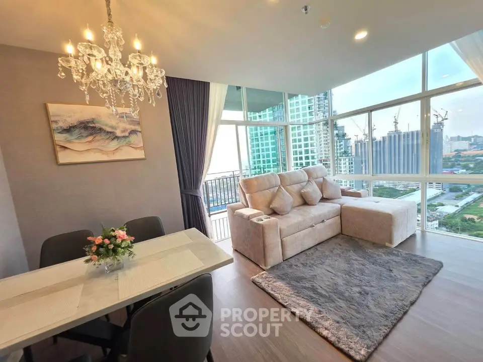 Luxurious living room with stunning city view, elegant chandelier, and cozy seating area in modern apartment.