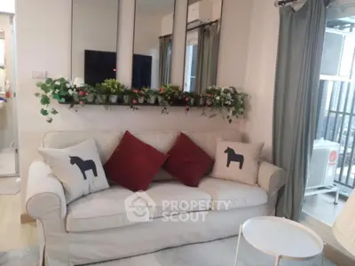 Cozy living room with elegant sofa and balcony view, perfect for relaxation.