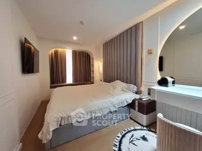 Elegant bedroom with modern decor and cozy ambiance, featuring a large bed and stylish lighting.