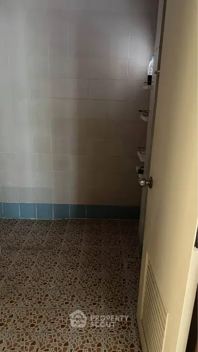 Simple bathroom with tiled floor and open door