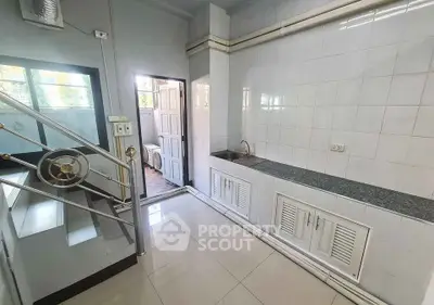 Spacious kitchen with sleek countertops and ample storage in modern home