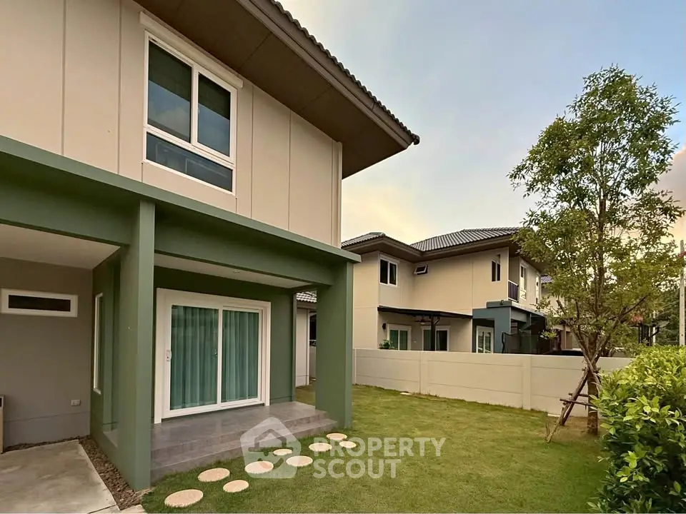 Modern two-story house with spacious garden and elegant exterior design.
