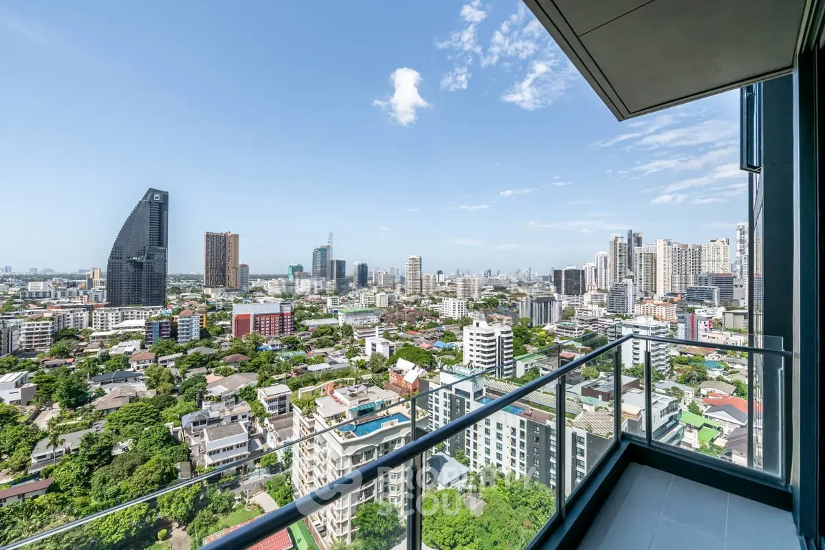 Stunning cityscape view from a modern high-rise balcony, showcasing urban skyline and lush greenery.