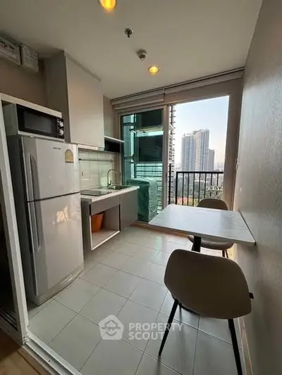 Modern kitchen with balcony view in high-rise apartment