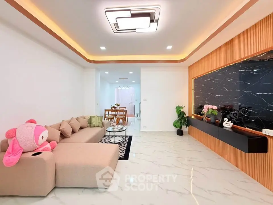 Modern living room with stylish decor and spacious layout, featuring elegant lighting and contemporary furniture.