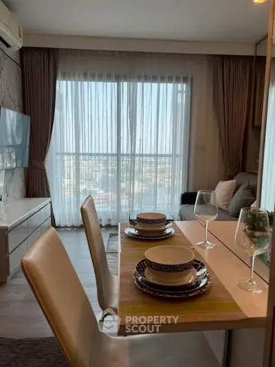 Modern living room with dining area and large window offering stunning city views.