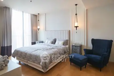 Luxurious bedroom with elegant decor and cozy seating area, perfect for relaxation and comfort.