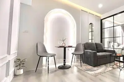 Modern living room with stylish furniture and elegant lighting, perfect for cozy gatherings.
