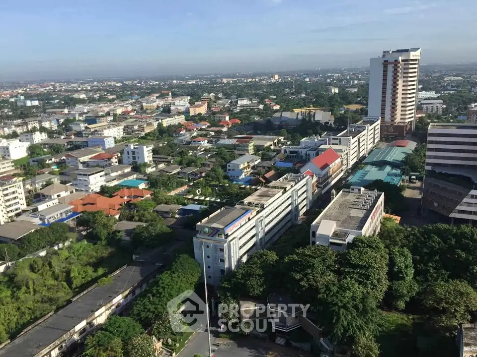 Stunning aerial view of urban landscape with high-rise buildings and lush greenery, perfect for real estate investment.