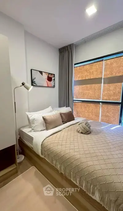 Cozy modern bedroom with stylish decor and natural light
