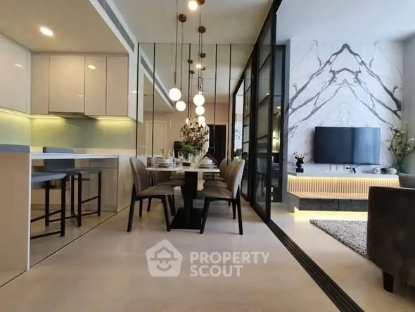 Luxurious open-plan living and dining area with modern decor and elegant lighting.