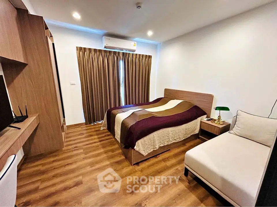 Modern bedroom with wooden flooring and stylish decor in a cozy apartment
