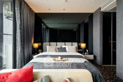 Luxurious bedroom with elegant decor and large windows offering natural light.