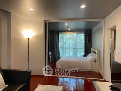 Spacious bedroom with cozy lighting and large window view