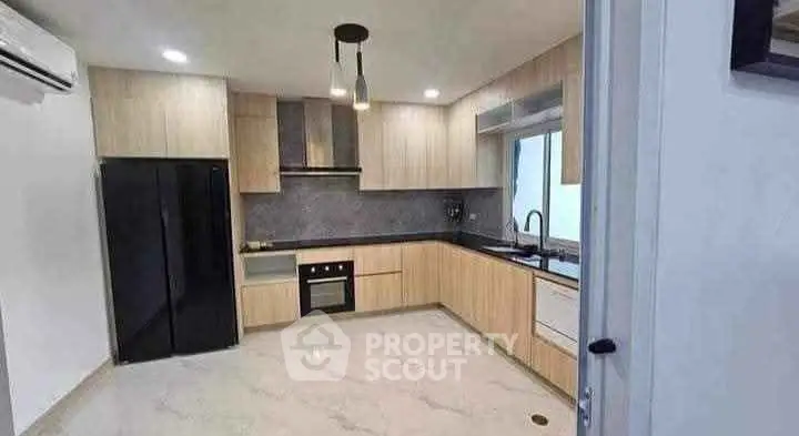 Modern kitchen with sleek cabinetry and built-in appliances in a stylish apartment.