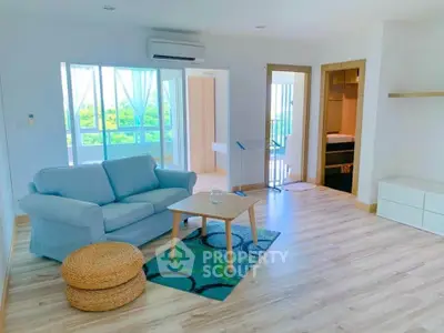 Bright and airy living room with modern decor and large windows offering a scenic view.