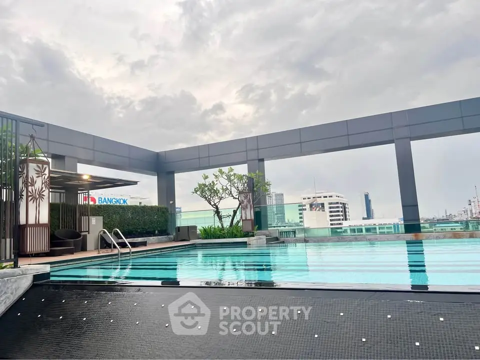 Luxurious rooftop pool with city skyline view in modern building