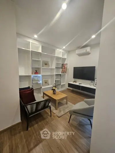 Modern living room with stylish furniture and built-in shelving