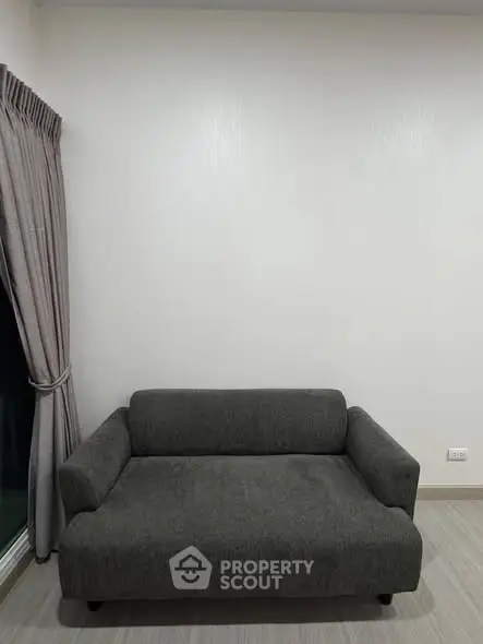 Minimalist living room with gray sofa and curtains