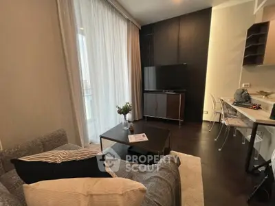 Modern living room with stylish decor and large TV, perfect for relaxation.