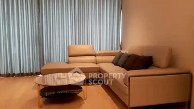 Modern living room with stylish beige sectional sofa and elegant coffee table