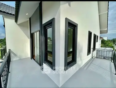 Modern corner unit with sleek balcony and stylish windows.