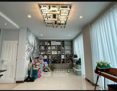 Spacious modern living room with stylish lighting and ample storage space.