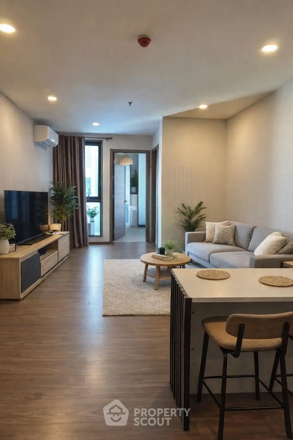 Modern living room with stylish decor and open layout, featuring a cozy sofa and entertainment center.