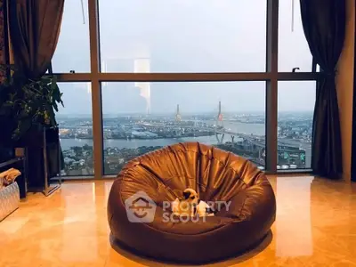 Luxurious living room with stunning city view and cozy bean bag seating.