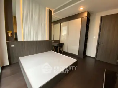 Modern bedroom with sleek dark wood finishes and built-in storage