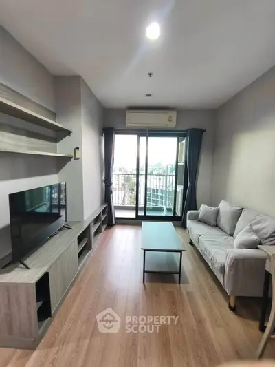 Modern living room with sleek furniture and balcony view in stylish apartment.