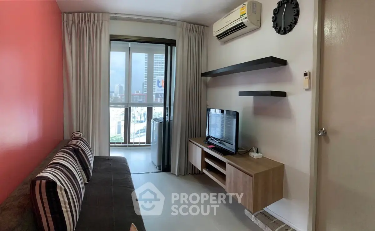 Cozy living room with modern decor and city view from balcony