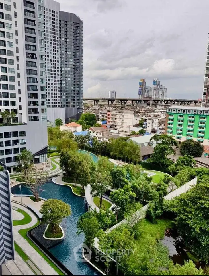 Stunning urban view from high-rise apartment with lush gardens and modern architecture.