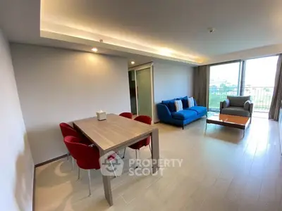 Spacious modern living room with stylish furniture and large windows offering natural light.