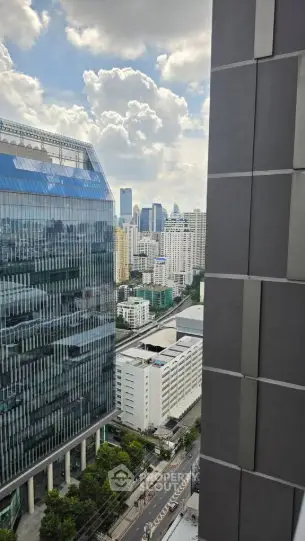 Stunning cityscape view from high-rise building window showcasing urban skyline and modern architecture.