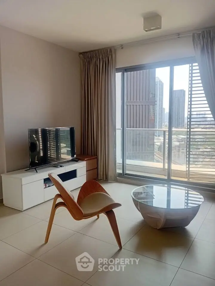 Modern living room with stylish furniture and city view balcony in high-rise apartment.