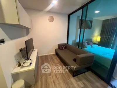 Modern living room with sleek design and cozy bedroom view