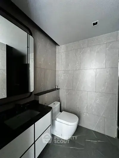 Modern bathroom with sleek design and elegant fixtures in a contemporary real estate property.
