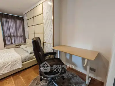 Modern bedroom with study area featuring a sleek desk and ergonomic chair, perfect for work-from-home setup.
