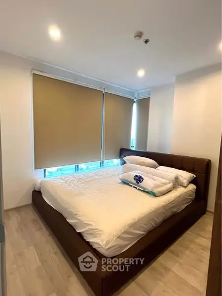 Modern bedroom with large windows and cozy bed in a stylish apartment.