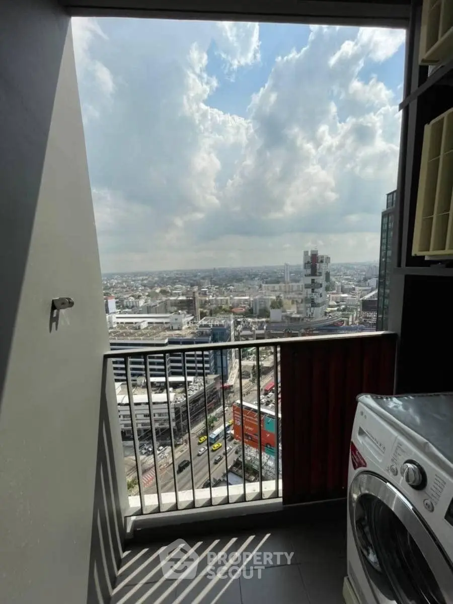 Stunning city view from a high-rise balcony with modern washing machine.