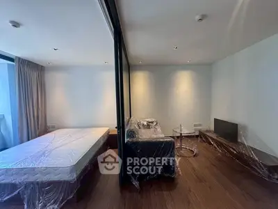 Modern apartment with spacious living area and large windows for natural light.