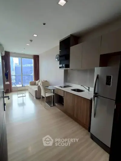 Modern open-layout kitchen and living room with city view in high-rise apartment