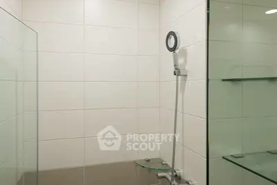 Modern bathroom with sleek shower design and glass shelves