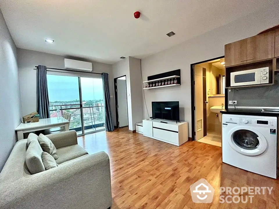 Modern living room with balcony view, washing machine, and stylish decor