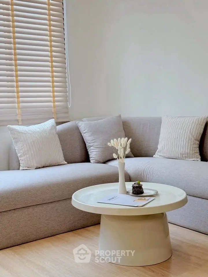Modern living room with stylish sofa and round coffee table, perfect for relaxation.