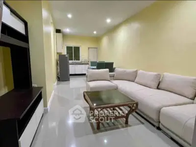 Spacious living room with modern furniture and open kitchen layout