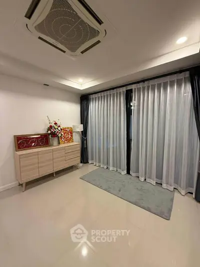 Spacious modern living room with elegant curtains and stylish decor