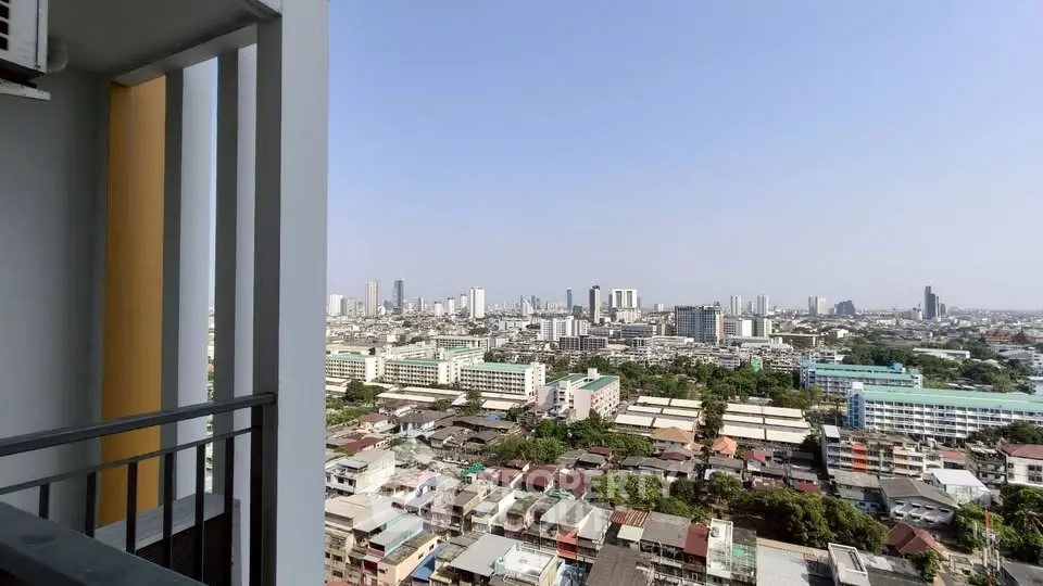 Stunning cityscape view from high-rise balcony showcasing urban skyline and residential areas.