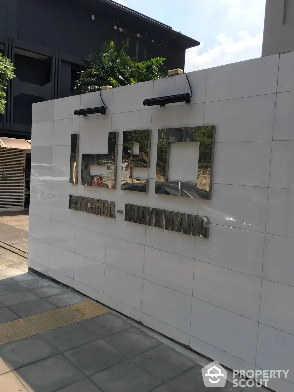 Modern building entrance with sleek signage and urban design